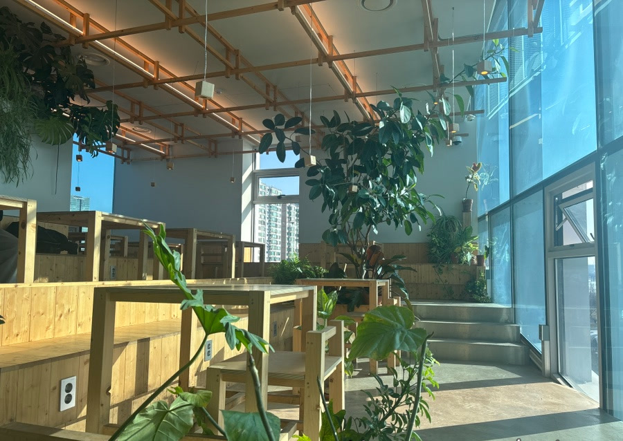 Wood seating and plants inside Urban Plant Hangang Bridge