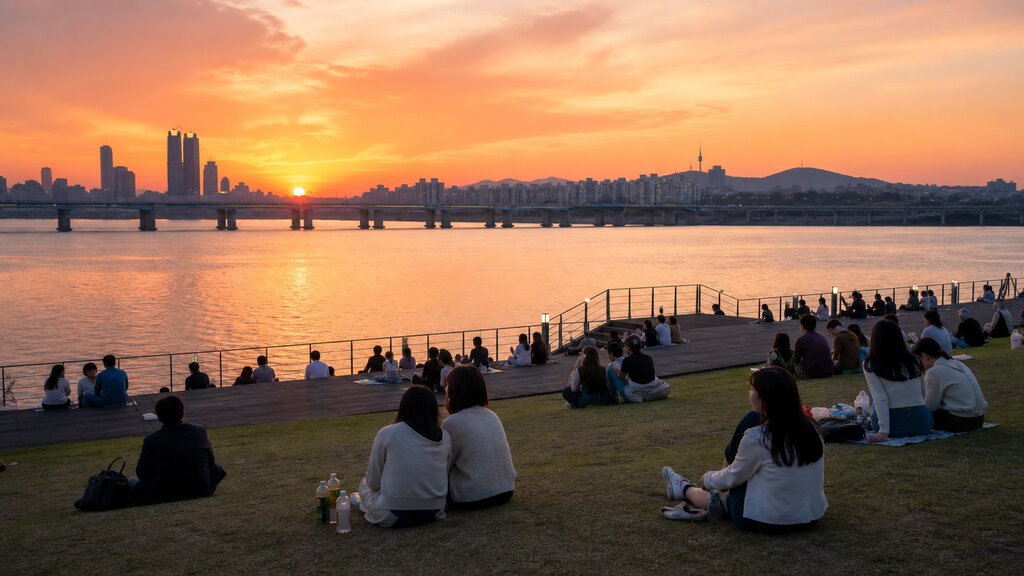 People relaxing by the Han River in Seoul at sunset, a calm welcoming moment for first-time visitors